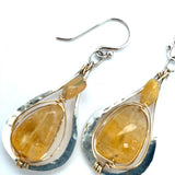Smooth citrine nuggets are wrapped in gold filled wire inside a sterling silver handmade drop earring with opal accent
