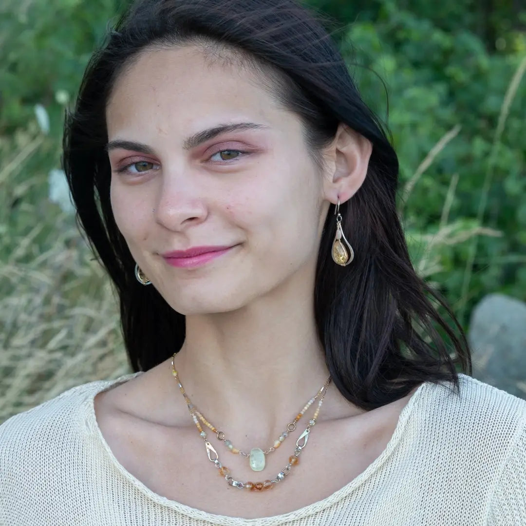 Smooth citrine nuggets are wrapped in gold filled wire inside a sterling silver handmade drop earring with opal accent