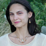 Smooth citrine nuggets are wrapped in gold filled wire inside a sterling silver handmade drop earring with opal accent