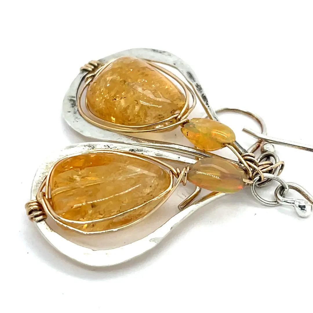 Smooth citrine nuggets are wrapped in gold filled wire inside a sterling silver handmade drop earring with opal accent