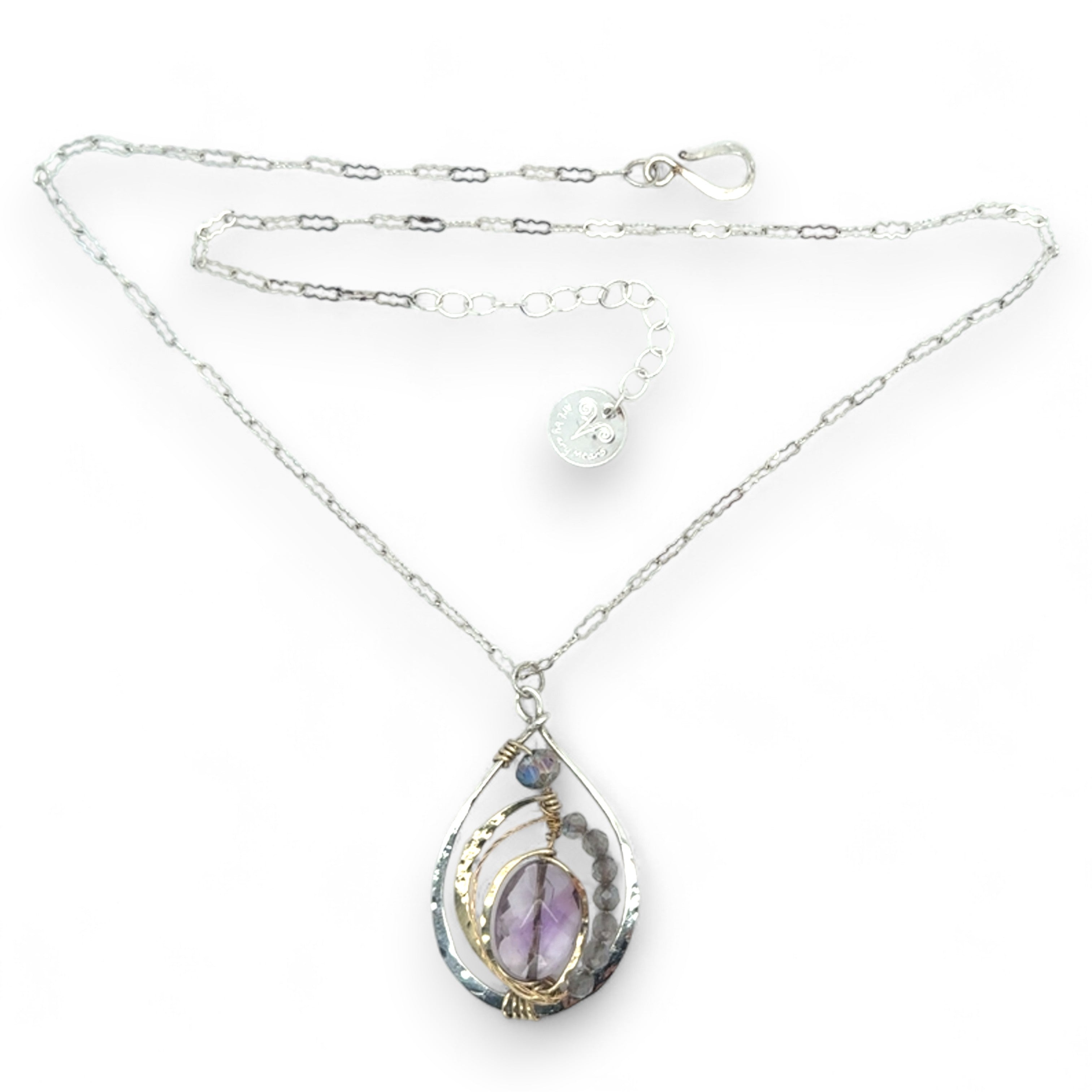 Teardrop-shaped sterling silver and brass pendatn with amethyst, labradorite, and crystal gemstones on delicate sterling silver chain
