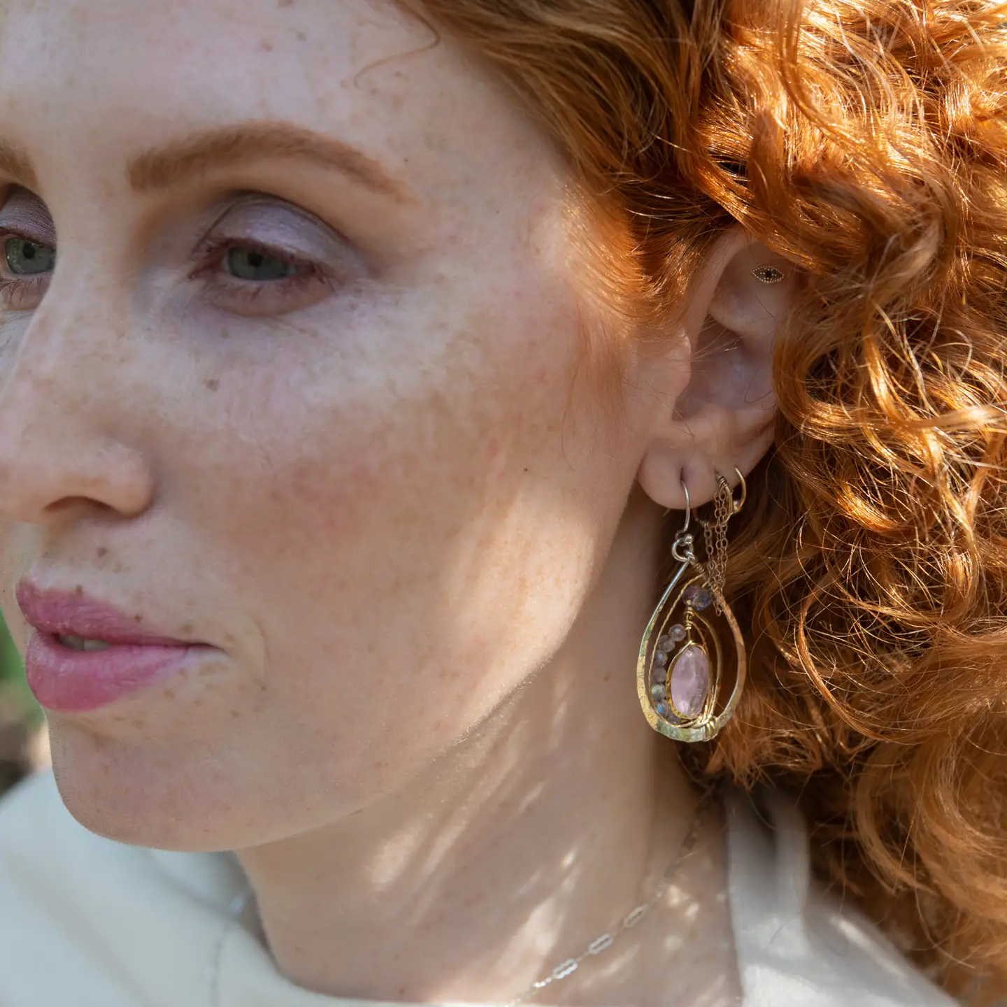 Teardrop-shaped sterling silver and brass earrings with amethyst, labradorite, and crystal gemstones 