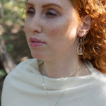 Teardrop-shaped sterling silver and brass earrings with amethyst, labradorite, and crystal gemstones 