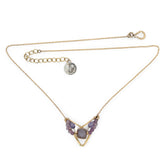 A gold-filled necklace with a bronze point pendant featuring a mauve moonstone faceted cube gemstone and petals of ombre faceted amethyst mini cube gemstones.