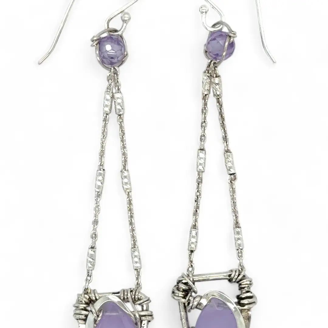 A pair of sterling silver earrings featuring faceted tear drop lavender jade stones with sterling silver chains and a cubic zirconia closure