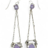 A pair of sterling silver earrings featuring faceted tear drop lavender jade stones with sterling silver chains and a cubic zirconia closure