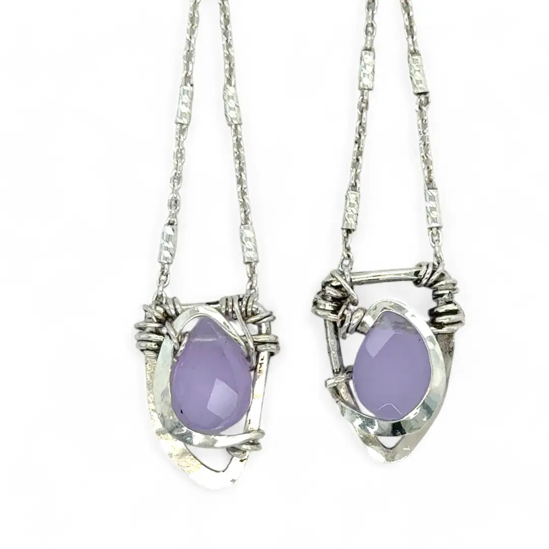 A pair of sterling silver earrings featuring faceted tear drop lavender jade stones with sterling silver chains and a cubic zirconia closure