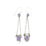 A pair of sterling silver earrings featuring faceted tear drop lavender jade stones with sterling silver chains and a cubic zirconia closure