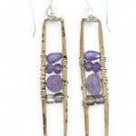 A pair of skinny tall bronze rectangle earrings with lilac purple amethyst pebbles, faceted amethyst gemstones, cubic zirconia purple drops, and crystal cubes stacked ontop of each other