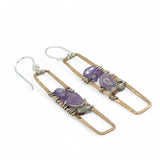 A pair of skinny tall bronze rectangle earrings with lilac purple amethyst pebbles, faceted amethyst gemstones, cubic zirconia purple drops, and crystal cubes stacked ontop of each other