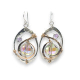 Hammered sterling silver oval earrings with hammered bronze accents holding and iridescent lilac crystal drop and amethyst gemstones