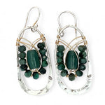 A pair of sterling silver hoop leaf stamped earrings with gold-filled woven bands, jade, and faceted emerald gemstones.