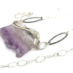 Raw edge amethyst slab held in waves of sterling silver and gold fill wires with a moonstone accent on delicate sterling silver chain with oxidized sparkly diamond cut link necklace