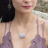 Raw edge amethyst slab held in waves of sterling silver and gold fill wires with a moonstone accent on delicate sterling silver chain with oxidized sparkly diamond cut link necklace