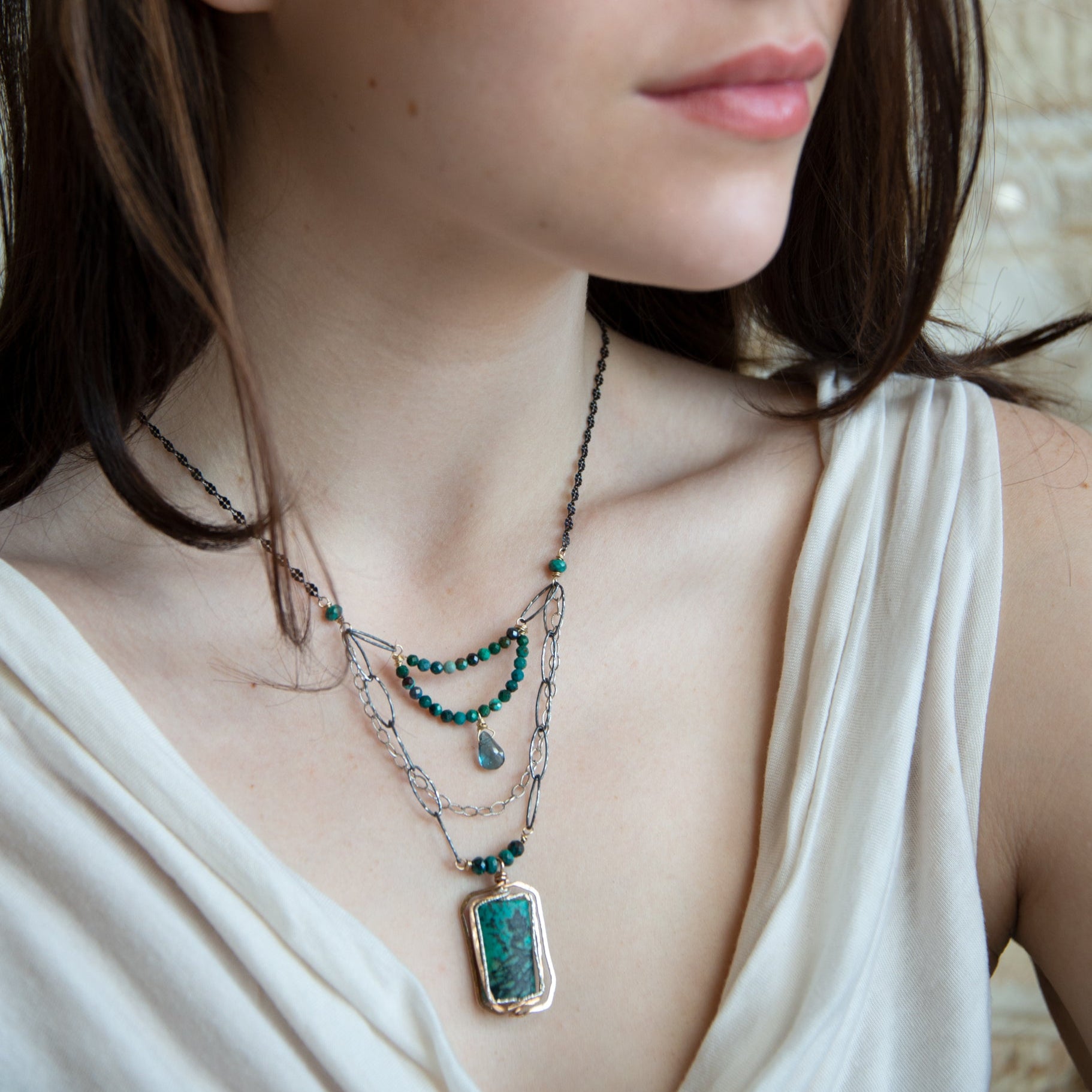 Turquoise rectangle wrapped in layers of hammered bronze and sterling silver wire pendant with another layer with chrysocolla and labradorite drop gemstones on oxidized sterling silver links and chain