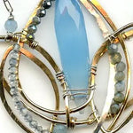 Lotus flower shaped bronze necklace with a large blue chalcedony gemstone point with blue quartz, labradorite, apatite, and sterling silver accents on delicate sterling silver chain