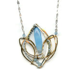 Lotus flower shaped bronze necklace with a large blue chalcedony gemstone point with blue quartz, labradorite, apatite, and sterling silver accents on delicate sterling silver chain