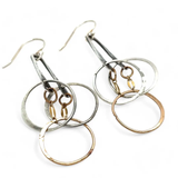a pair of oxidized fern stamped arch earrings with sterling silver and bronze interlocked rings