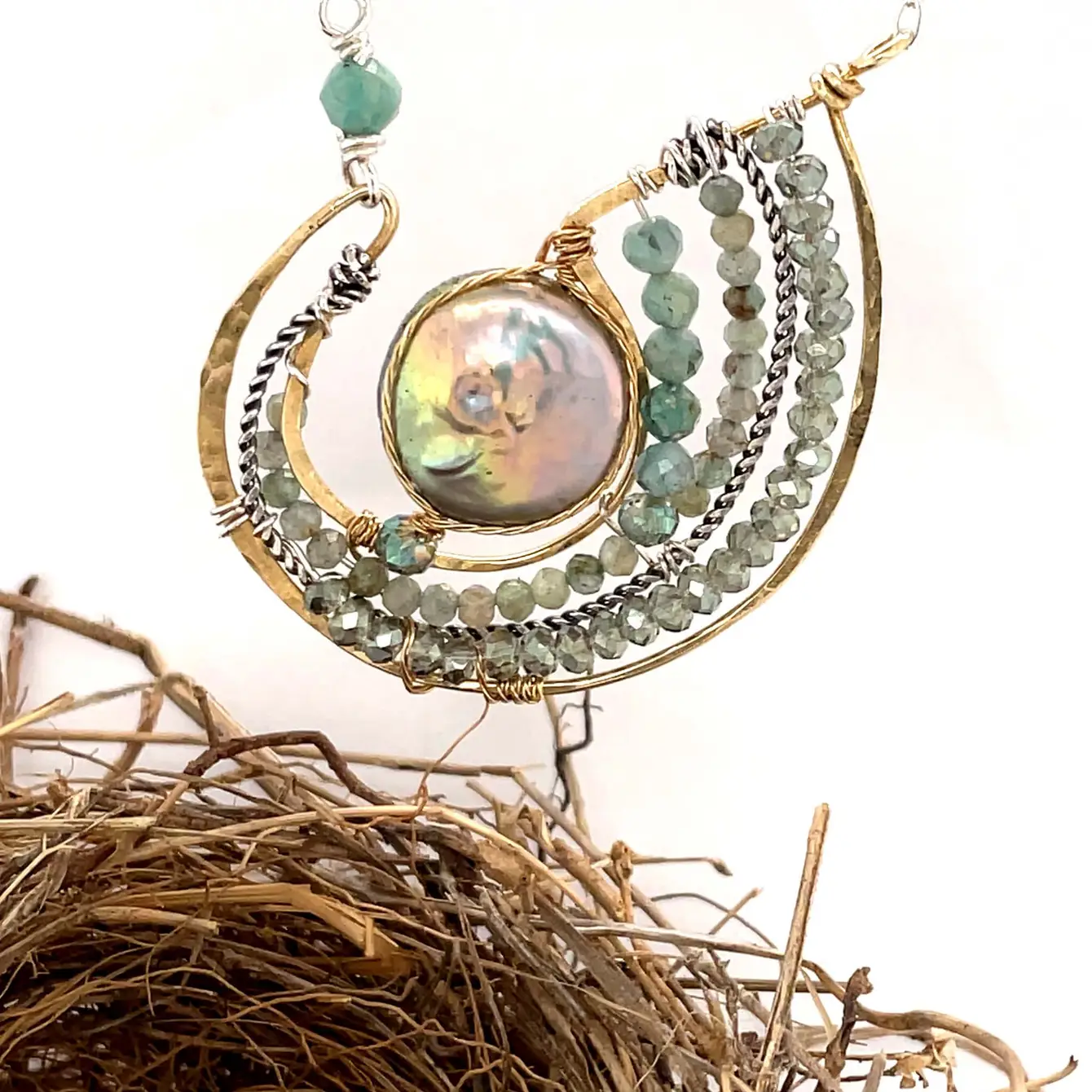 Mint fresh water pearl coin held within a brass pendant necklace filled with amazonite and crystal gemstones along side with oxidized sterling silver twist wire