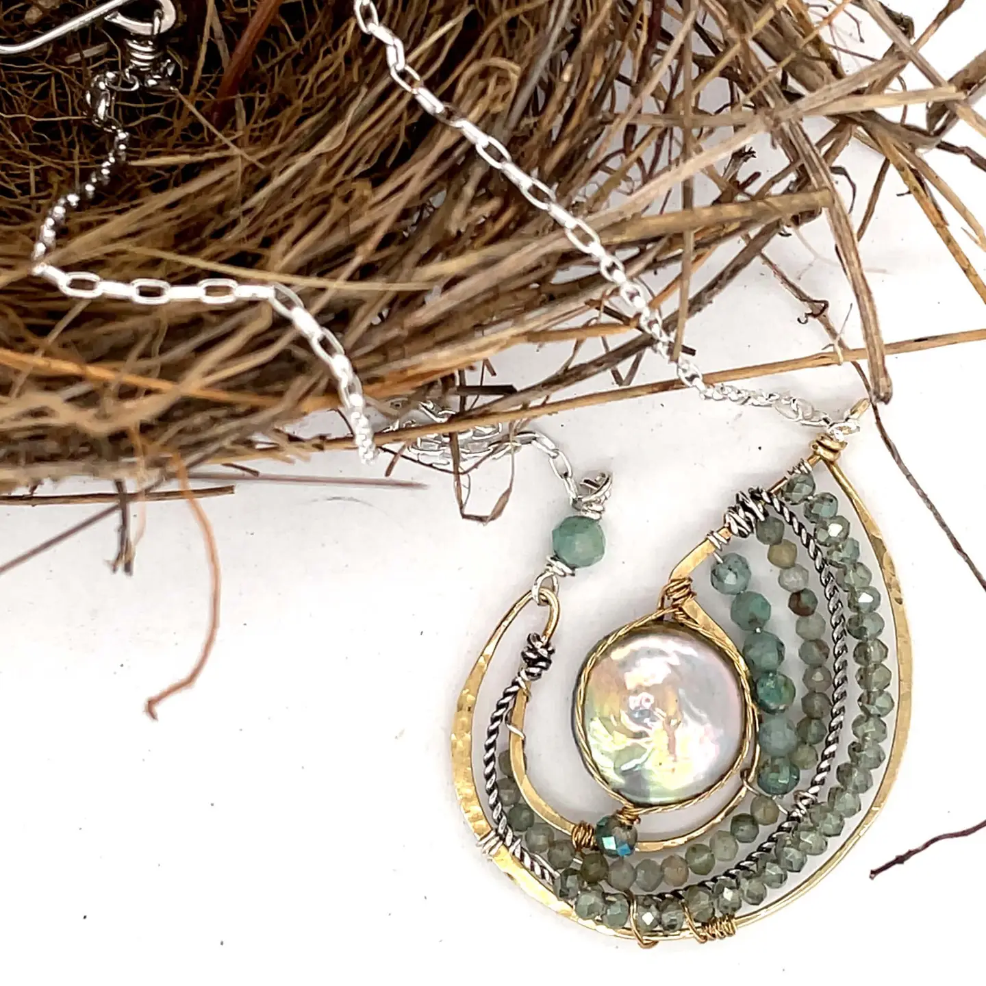 Mint fresh water pearl coin held within a brass pendant necklace filled with amazonite and crystal gemstones along side with oxidized sterling silver twist wire