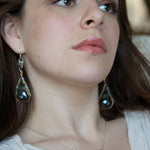 Mint fresh water pearl coin held within a brass pendant necklace filled with amazonite and crystal gemstones along side with oxidized sterling silver twist wire