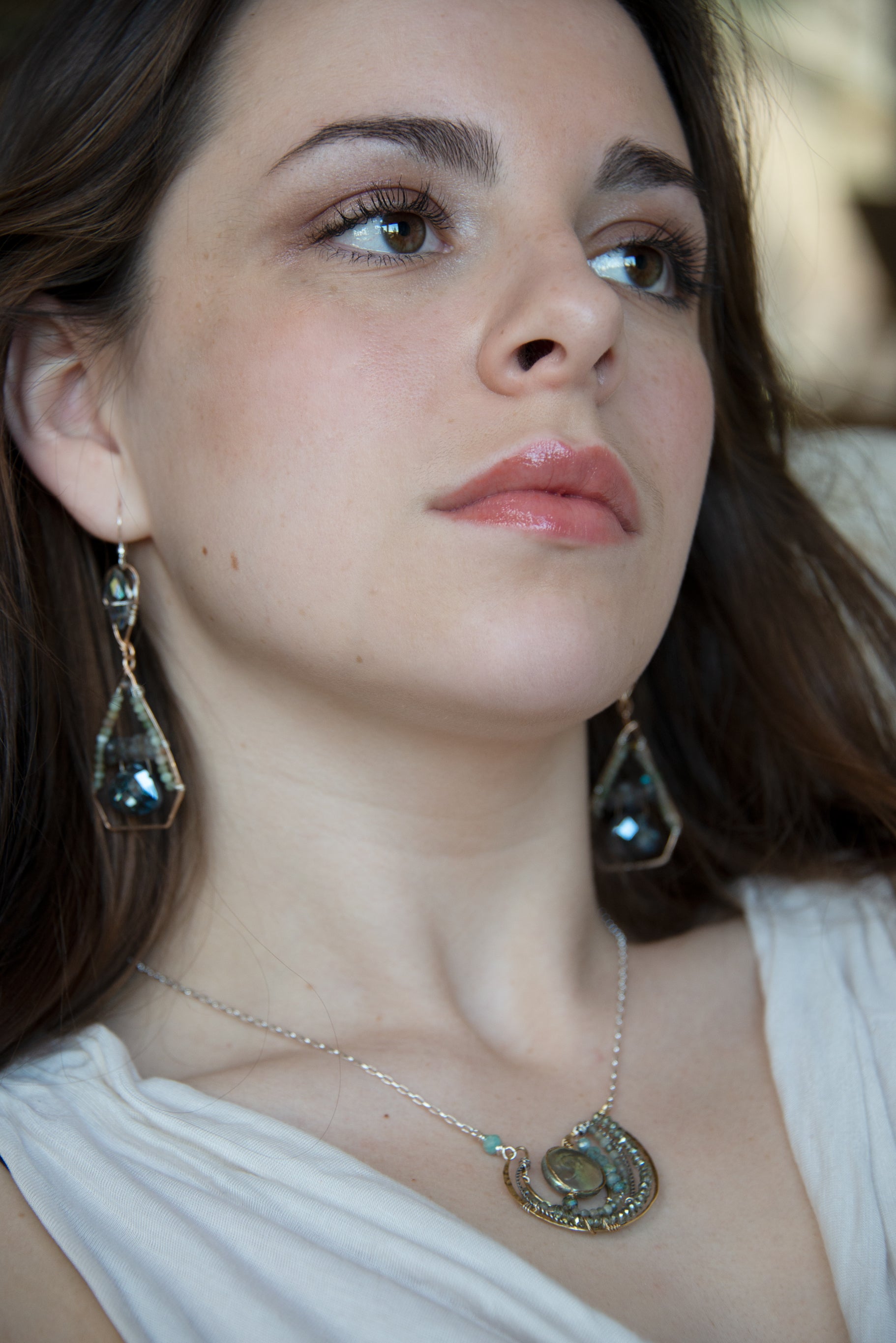 Mint fresh water pearl coin held within a brass pendant necklace filled with amazonite and crystal gemstones along side with oxidized sterling silver twist wire