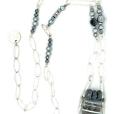 Sterling silver sparkly necklace with fresh water pearl, pyrite, and labradorite built into the chain with  a geometric pendant, featuring a blue lace agate arrow gemstone 