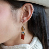Brick red jasper rectangle wrapped in gold filled wire and cat's eye gemstones hanging from a smokey quartz wrapped in gold filled wire earrings