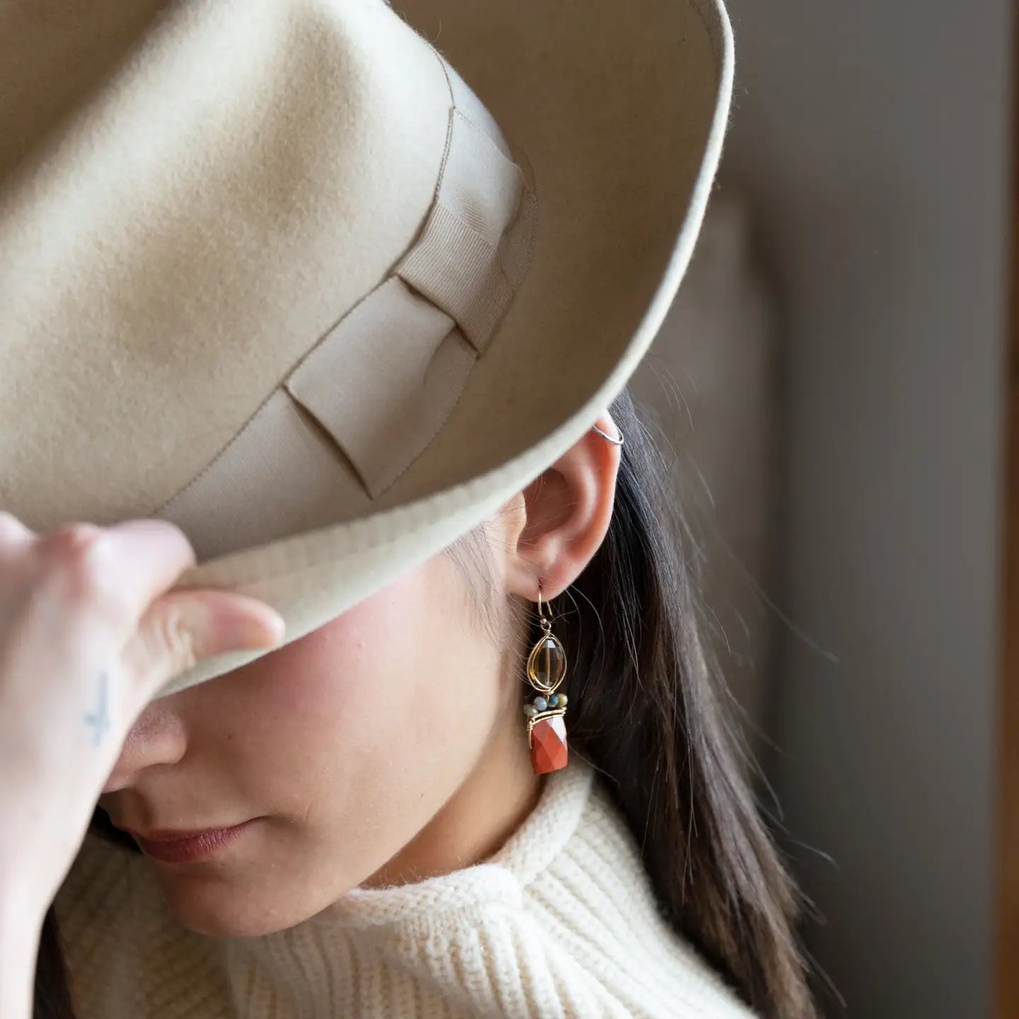 Brick red jasper rectangle wrapped in gold filled wire and cat's eye gemstones hanging from a smokey quartz wrapped in gold filled wire earrings