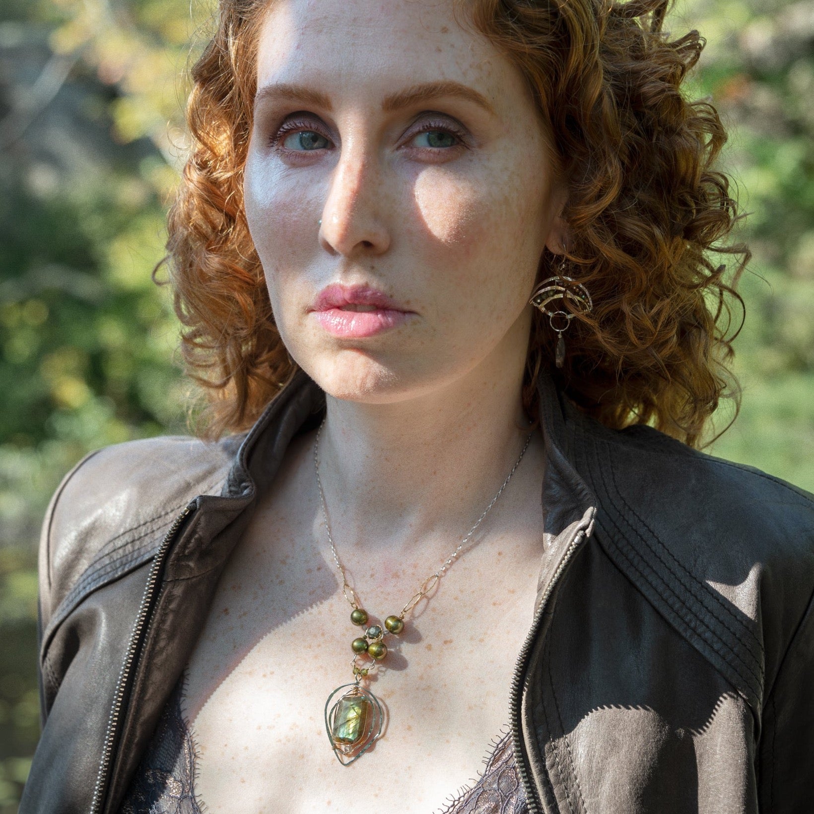 Handmade sterling silver necklace with flashy green labradorite accented with olive green fresh water pearl, rough pyrite, and cubic zirconia gemstones. Gold-filled wire and diamond cut links, with sterling silver box chain