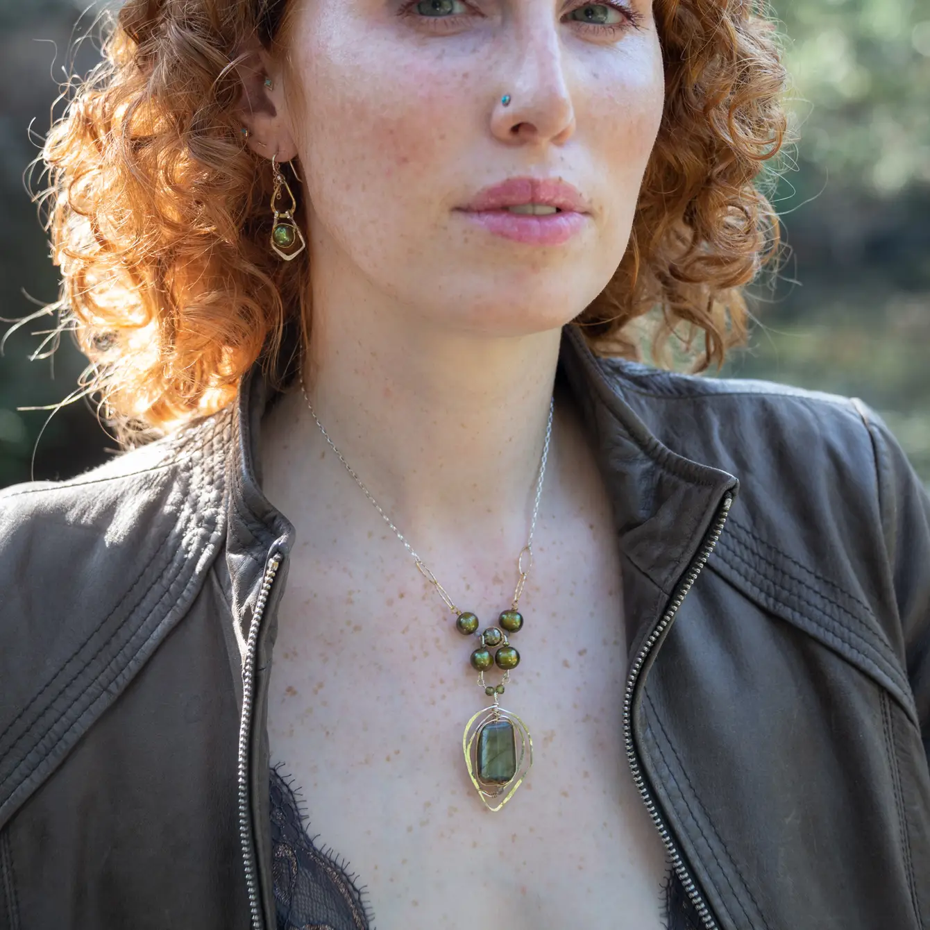 Handmade sterling silver necklace with flashy green labradorite accented with olive green fresh water pearl, rough pyrite, and cubic zirconia gemstones. Gold-filled wire and diamond cut links, with sterling silver box chain