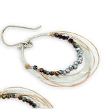 Sterling silver hammered hoop earrings lined with metallic crystal wrapped in gold filled wire