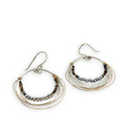 Sterling silver hammered hoop earrings lined with metallic crystal wrapped in gold filled wire