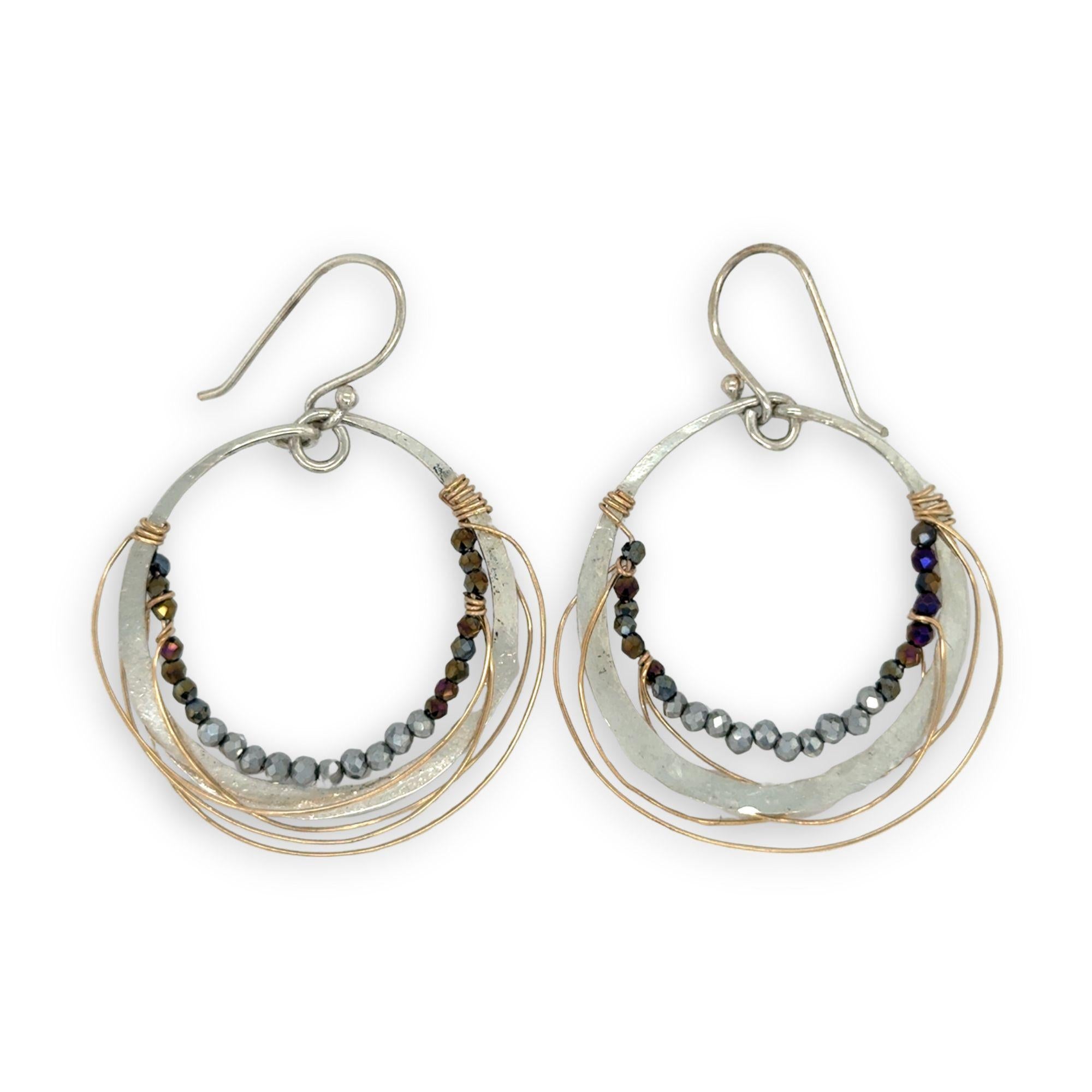 Sterling silver hammered hoop earrings lined with metallic crystal wrapped in gold filled wire