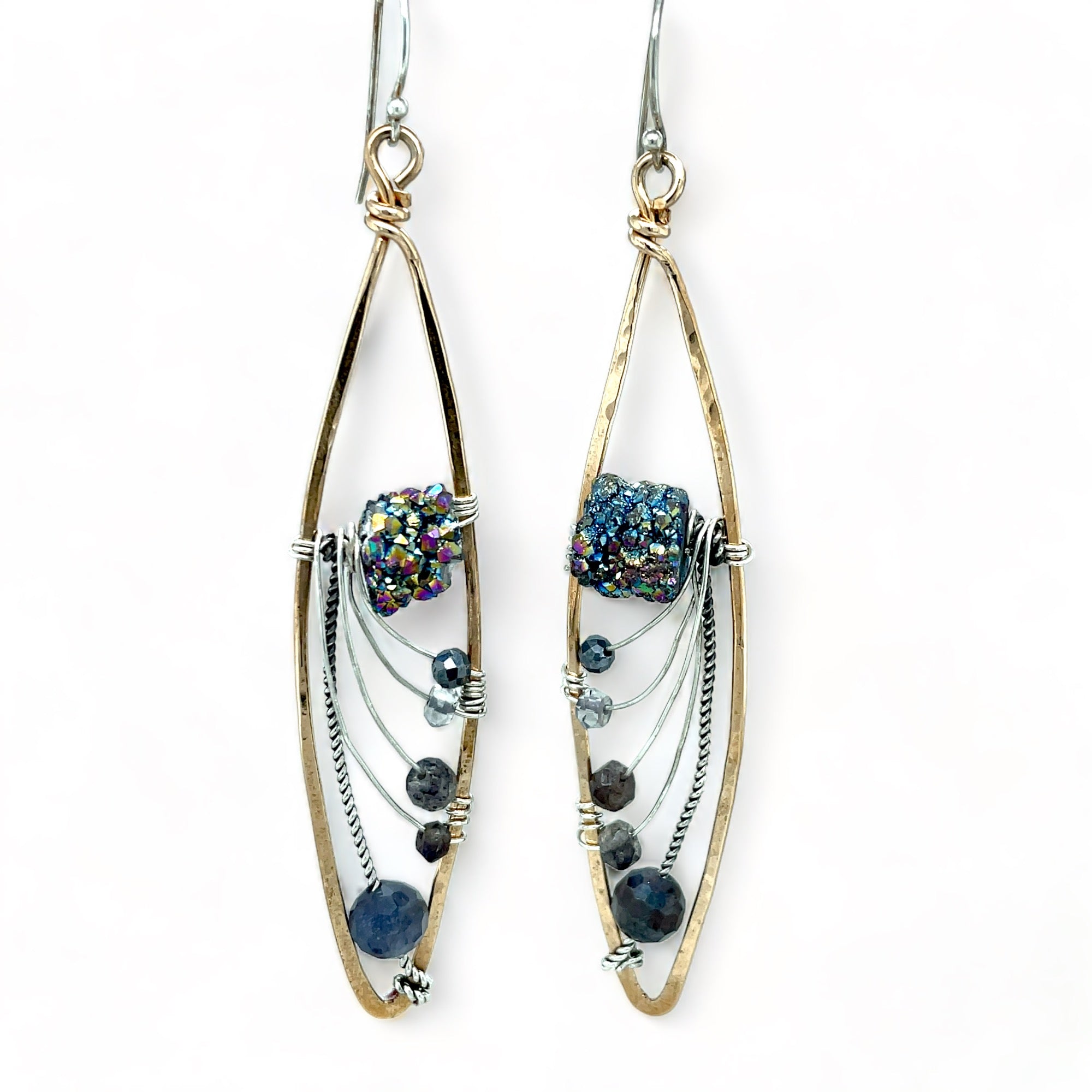 A pair of bronze marquise earrings, with iolite gemstones, and a central sparkling meteorite-like texture, suspended from sterling silver French hooks.
