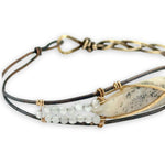 Half oxidized sterling, half braided brass bracelet with a large opal teardrop accented with moonstone gemstones