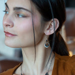 Pair of earrings with brass and silver teardrop designs with chrysocolla, fresh water pearl, and a mini smooth teardrop smokey quartz