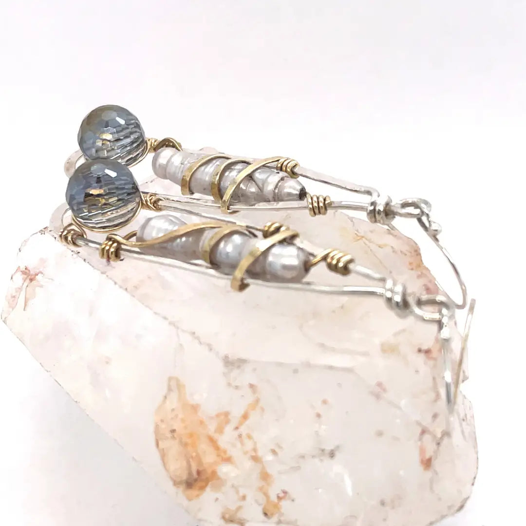 Sterling silver skinny drop earrings with fresh water stick pearls wrapped in brass wire and a crystal disco ball nested in gold filled wire