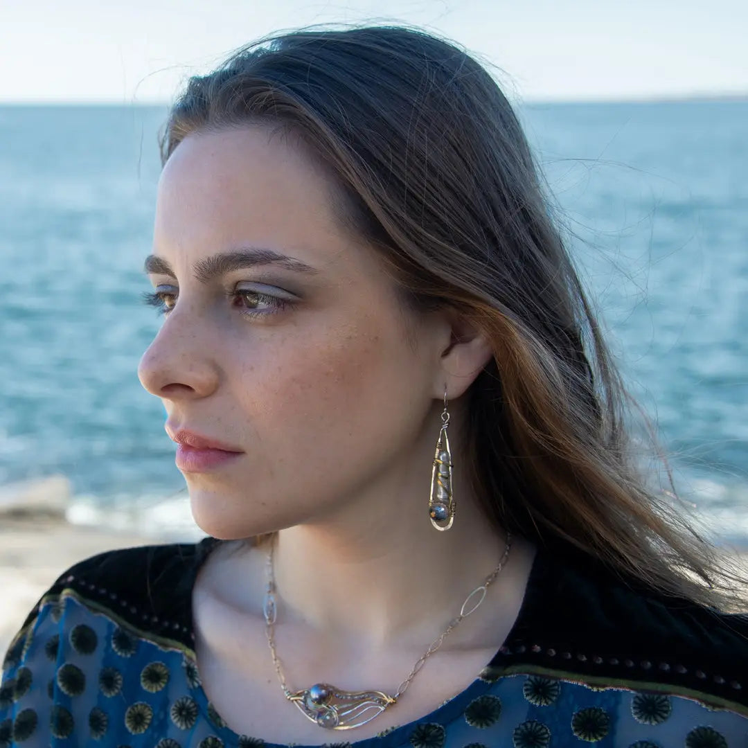 Sterling silver skinny drop earrings with fresh water stick pearls wrapped in brass wire and a crystal disco ball nested in gold filled wire