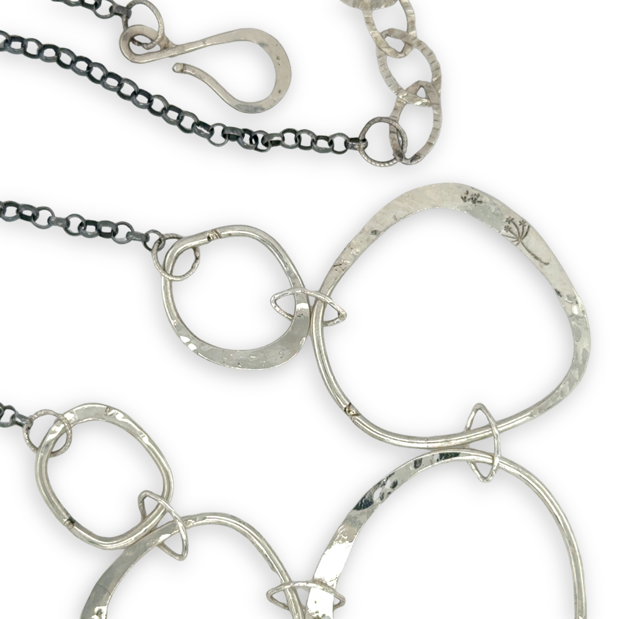 handmade hammered floral stamped sterling silver organic shapes varied in size hanging from oxidized sterling silver dainty chain necklace