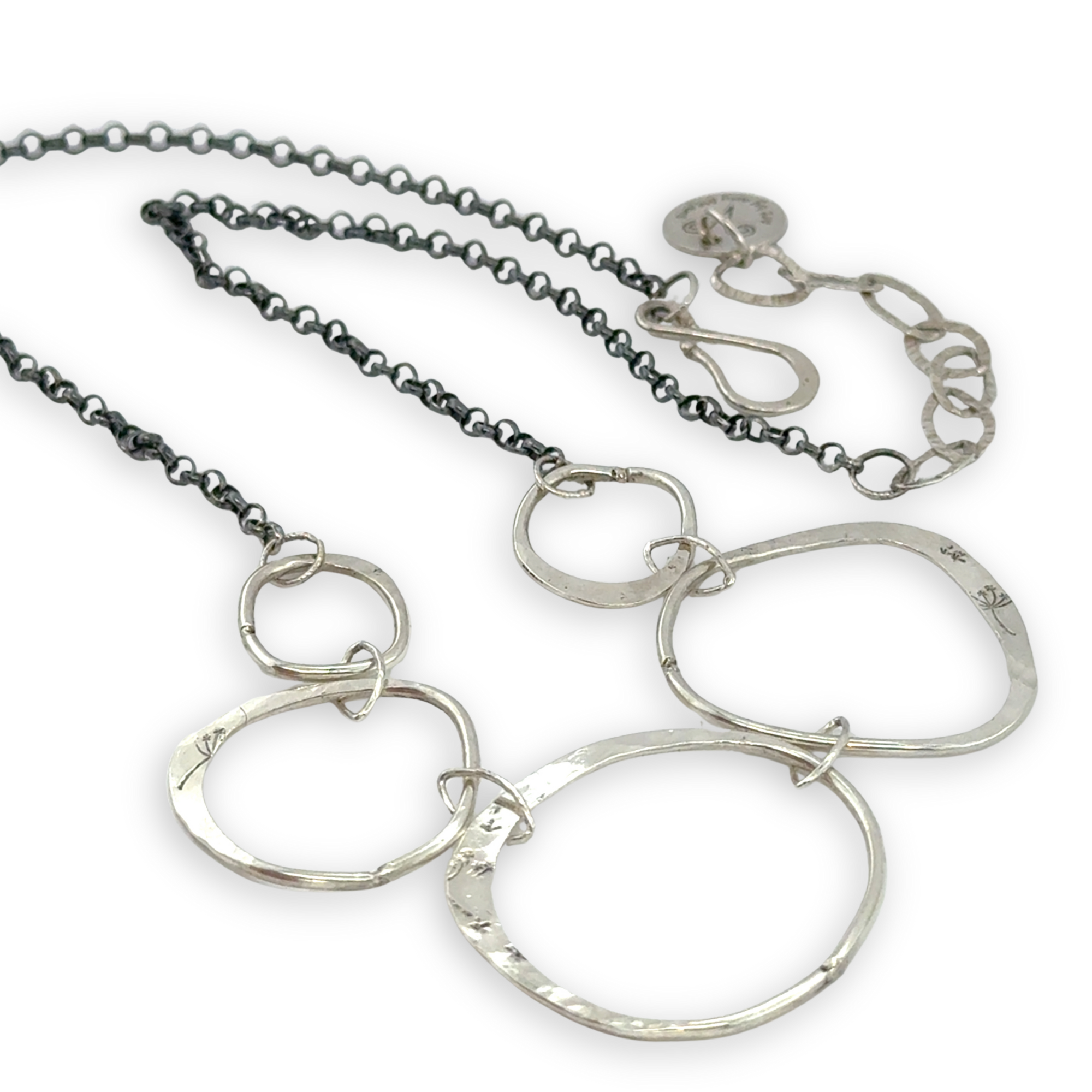 handmade hammered floral stamped sterling silver organic shapes varied in size hanging from oxidized sterling silver dainty chain necklace