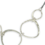handmade hammered floral stamped sterling silver organic shapes varied in size hanging from oxidized sterling silver dainty chain necklace