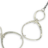 handmade hammered floral stamped sterling silver organic shapes varied in size hanging from oxidized sterling silver dainty chain necklace