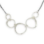 handmade hammered floral stamped sterling silver organic shapes varied in size hanging from oxidized sterling silver dainty chain necklace