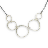 handmade hammered floral stamped sterling silver organic shapes varied in size hanging from oxidized sterling silver dainty chain necklace