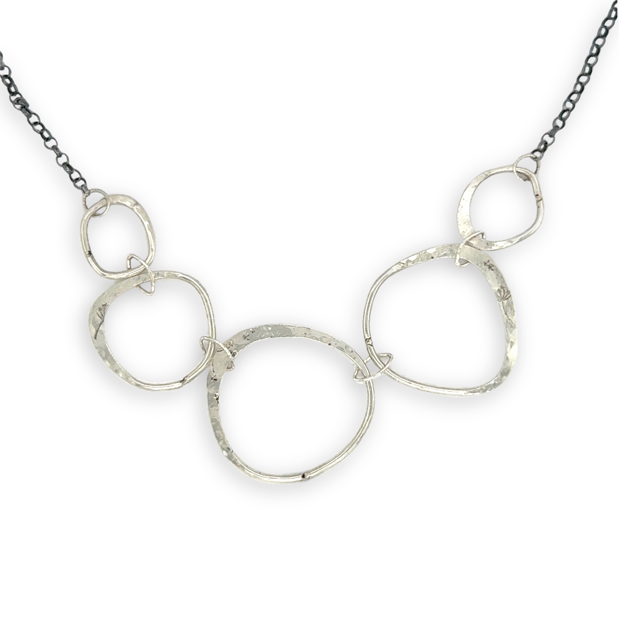 handmade hammered floral stamped sterling silver organic shapes varied in size hanging from oxidized sterling silver dainty chain necklace