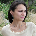 A pair of sterling silver channel drop earrings with blue opal nuggets and blue tourmaline micro faceted gemstones, featuring tiny crystal accents.