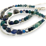 A pair of sterling silver channel drop earrings with blue opal nuggets and blue tourmaline micro faceted gemstones, featuring tiny crystal accents.