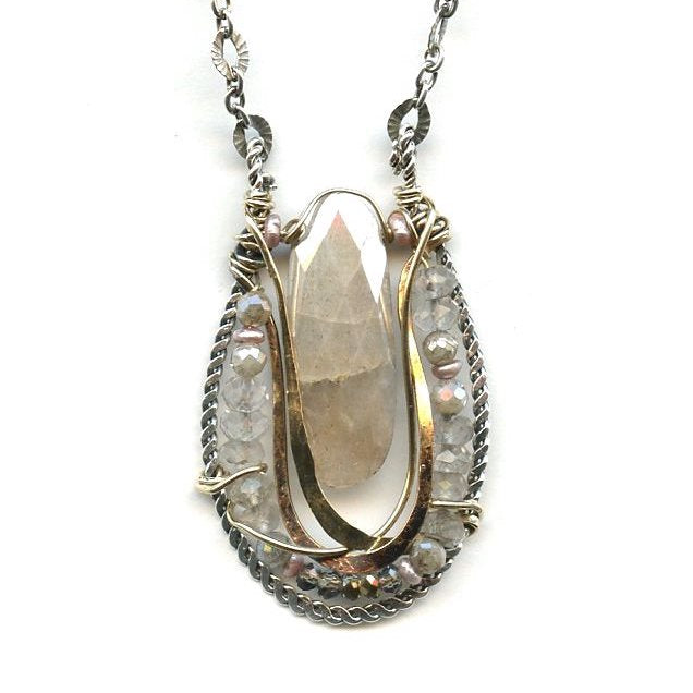A necklace featuring a faceted oval moonstone gemstone set in a basket of hammered brass on darkened sterling silver twist pendant, accompanied by a channel of faceted rose quartz and fresh water pearls