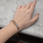 Bronze skinny bracelet with flashy moonstone, opal, and pyrite gemstones